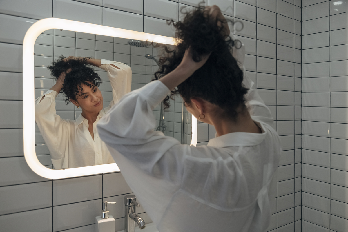 Woman looking at her beauty in the mirror