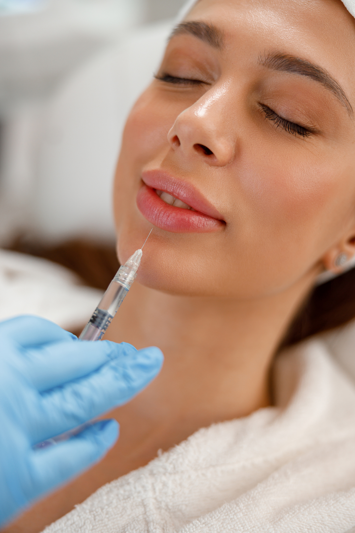 Closeup of young woman getting rejuvenating injections